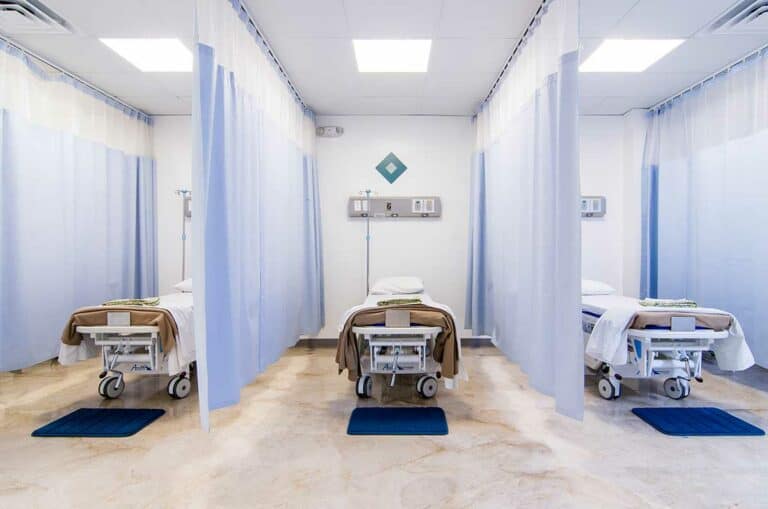 Recovery area with curtained beds at SER Hospital