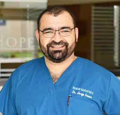 Our Practice's dental professional standing in scrubs outside our dental office.