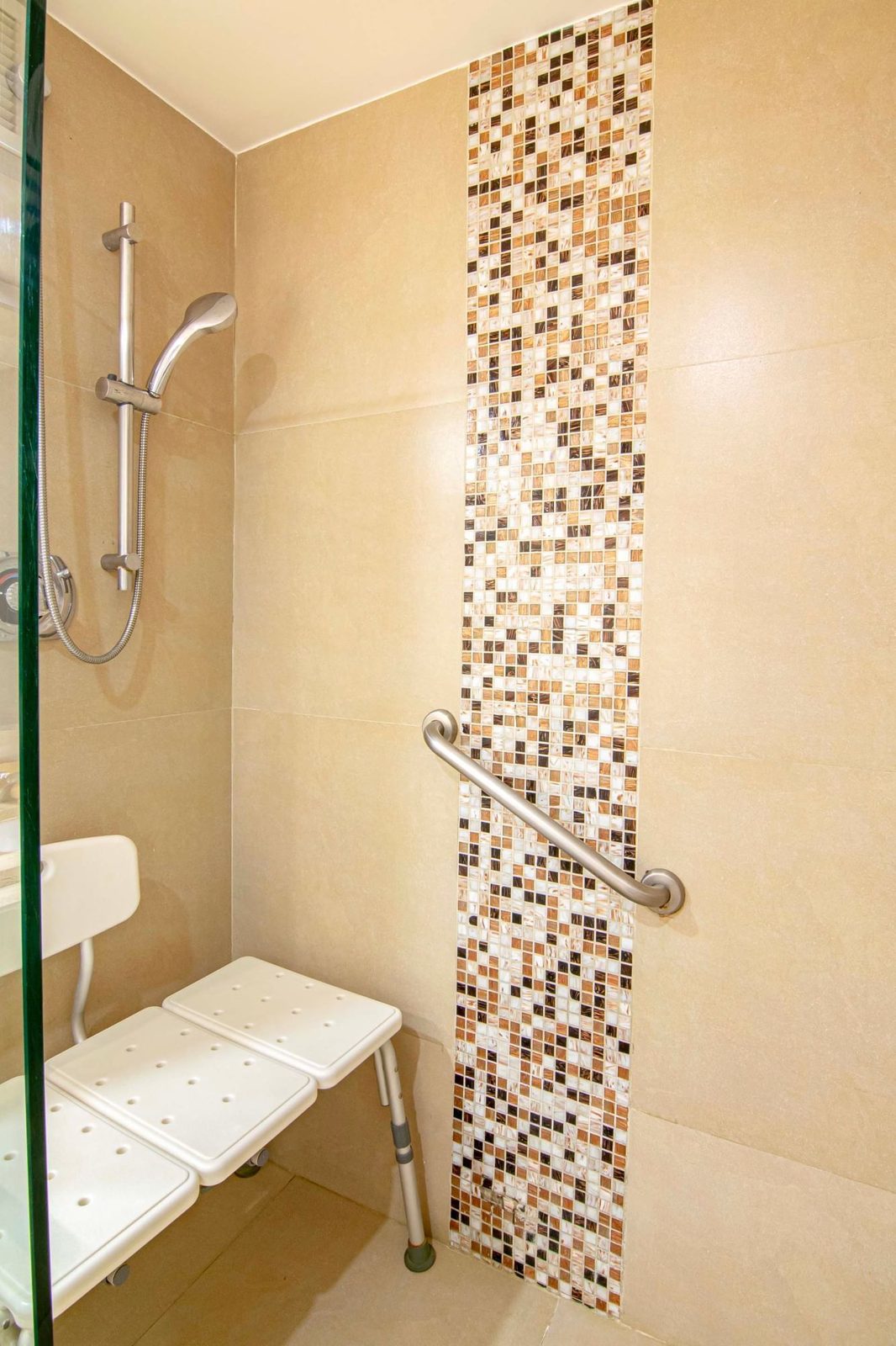 Accessible shower with grab bar and shower chair